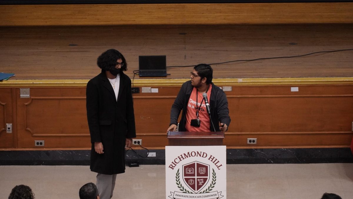The two hosts, senior Zachary Khan and senior Satesh Singh  introduce the speakers and their topics.